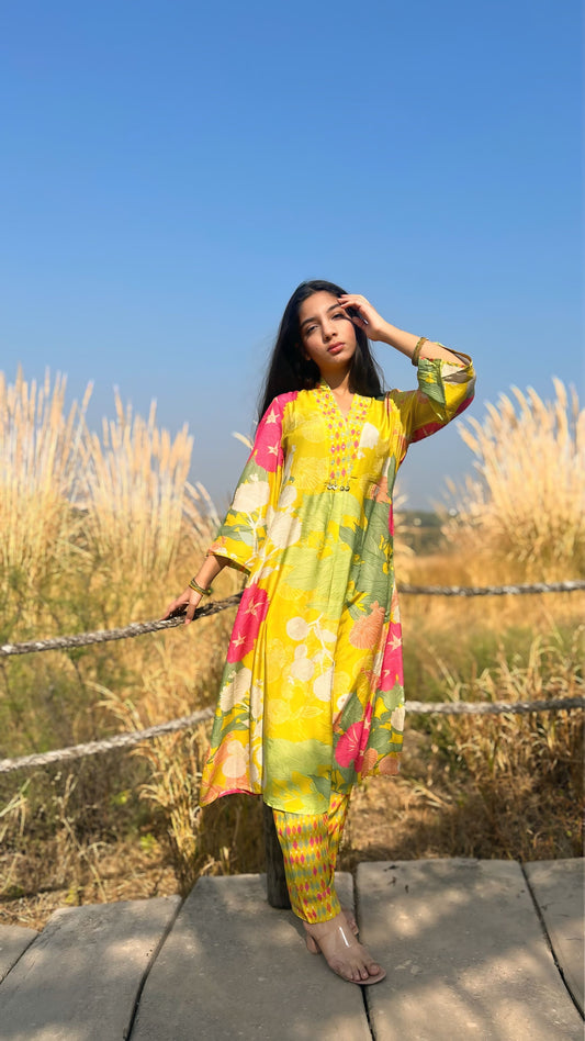 Model in a vibrant lime green Flower Gloss set featuring floral patterns, surrounded by nature.